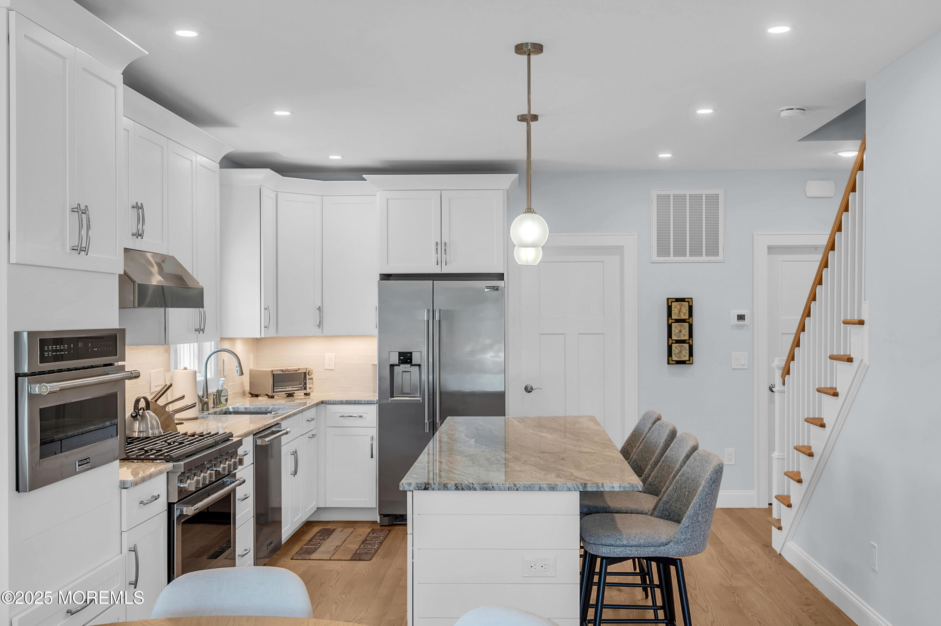 1503 Grand Central Avenue, Unit 2 Lavallette, NJ 08735 - Photo 11 of 47 a kitchen with stainless steel appliances kitchen island granite countertop a sink a stove a refrigerator cabinets and chairs