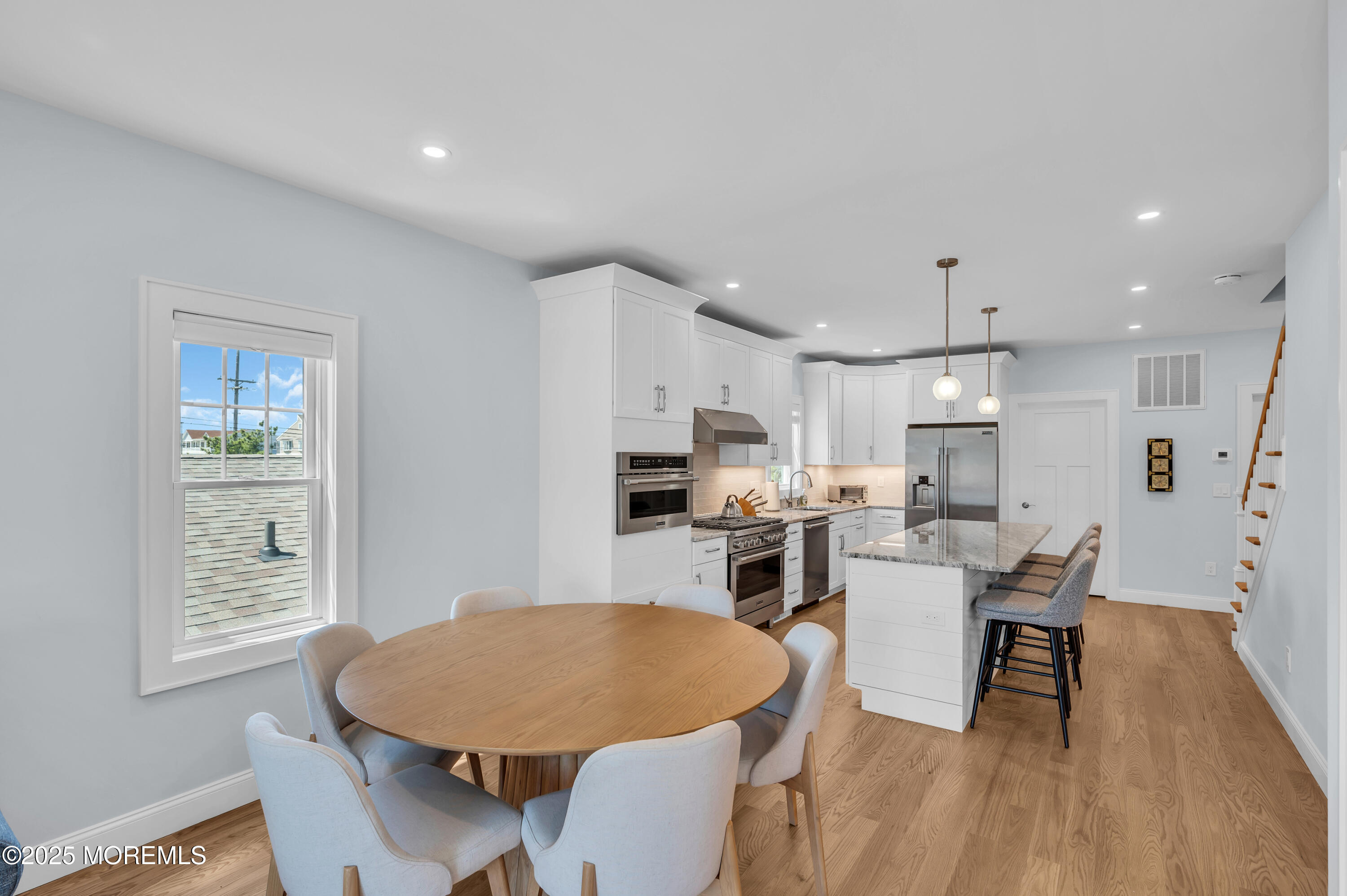 1503 Grand Central Avenue, Unit 2 Lavallette, NJ 08735 - Photo 12 of 47 a living room with stainless steel appliances a dining table wooden floor and a kitchen view