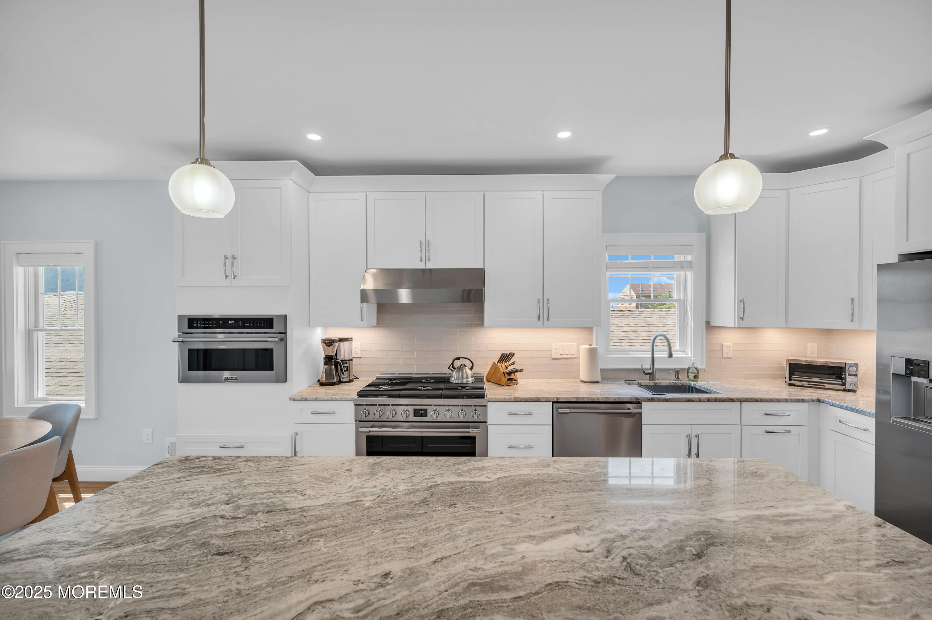 1503 Grand Central Avenue, Unit 2 Lavallette, NJ 08735 - Photo 18 of 47 a kitchen with kitchen island granite countertop a stove cabinets and wooden floor