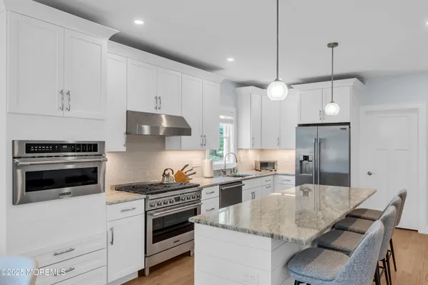 a kitchen with a stove a sink and a refrigerator