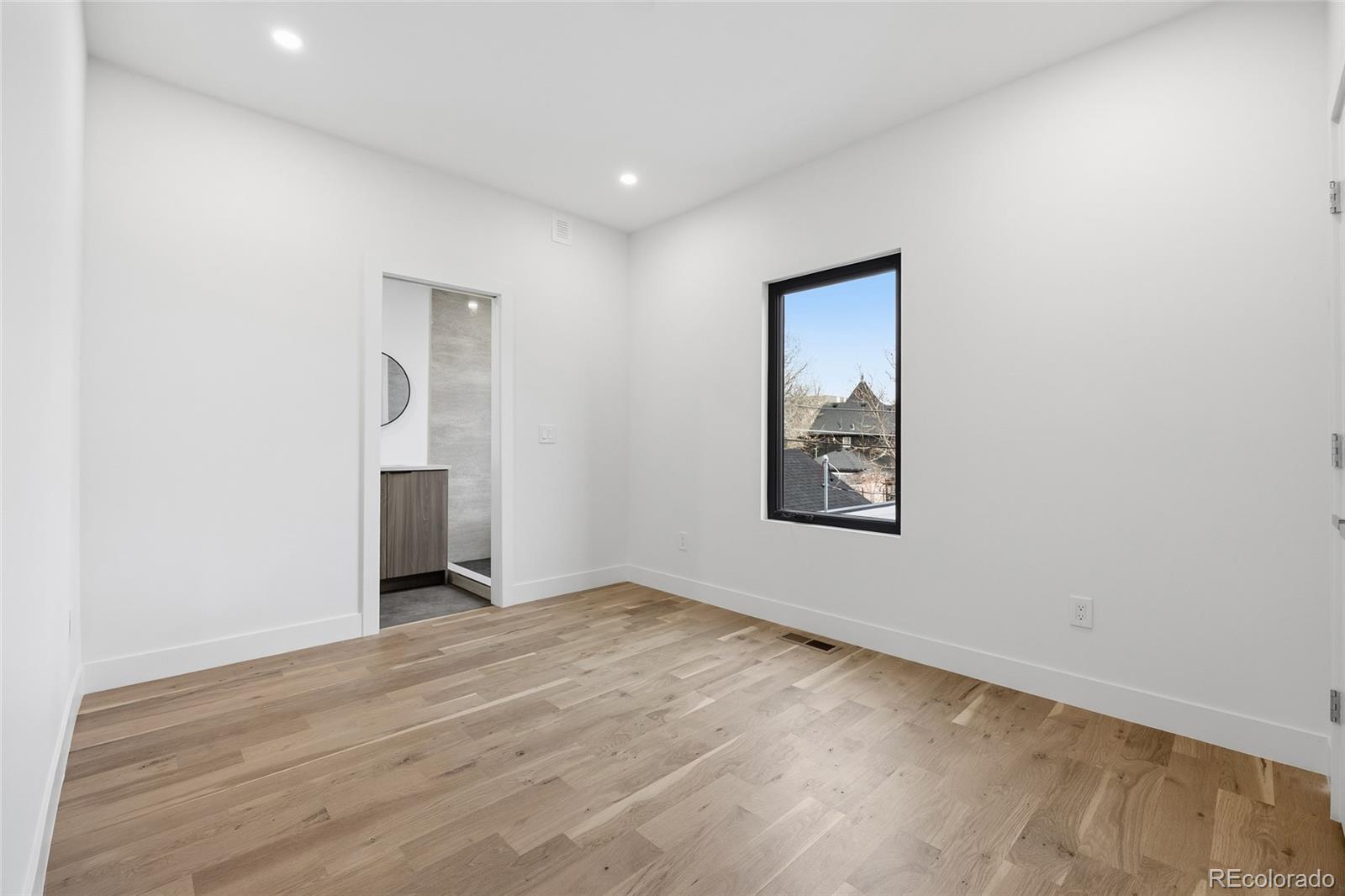 1448 Stuart Street Denver, CO 80204 - Photo 16 of 27 an empty room with a window