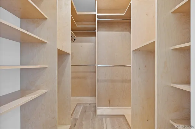 a bathroom with a granite countertop sink a toilet a mirror and shower