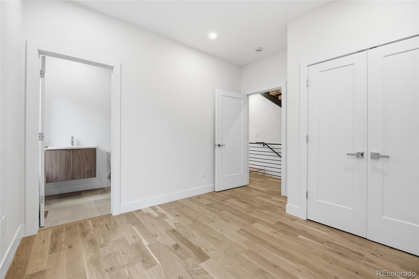 1448 Stuart Street Denver, CO 80204 - Photo 21 of 27 a view of a room with wooden floor and bathroom