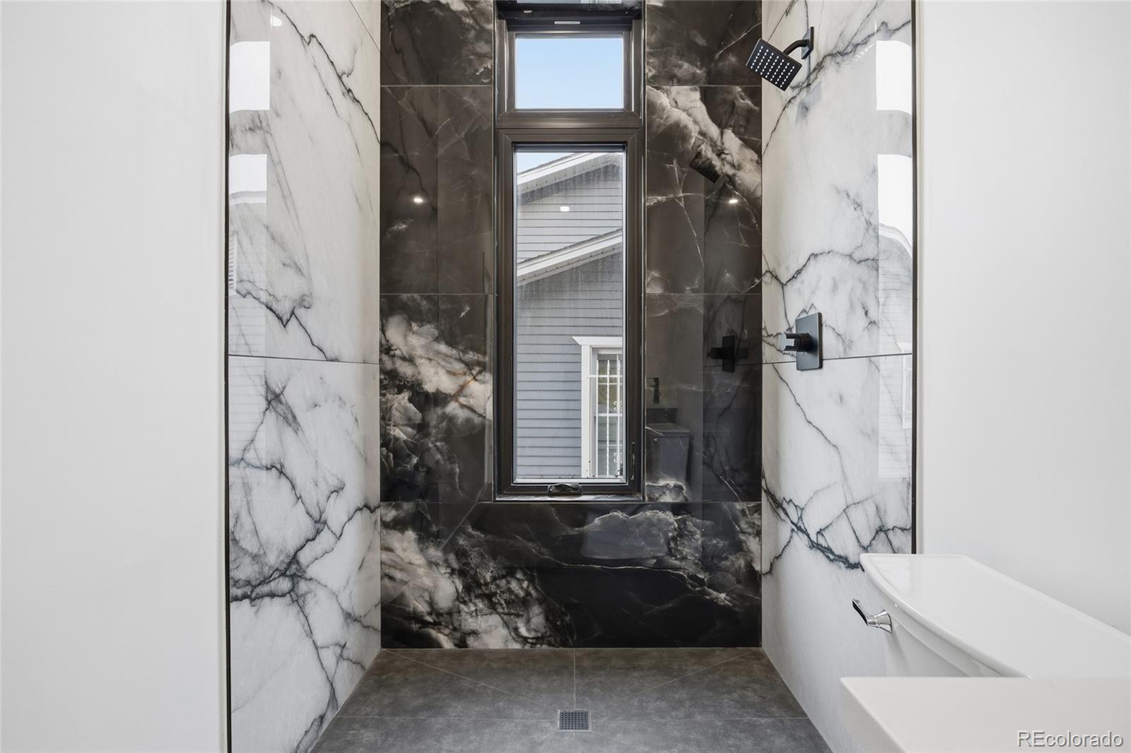 1448 Stuart Street Denver, CO 80204 - Photo 27 of 27 a bathroom with a bathtub and shower