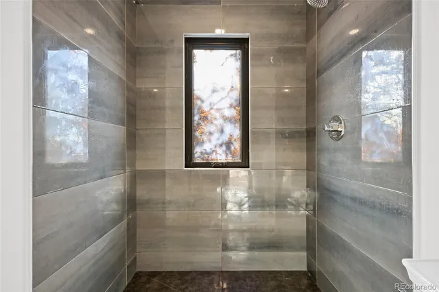 a view of an empty room with a fireplace and a window
