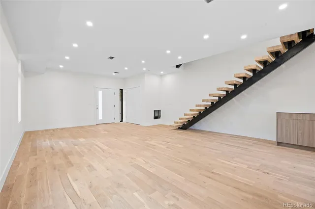 a view of kitchen with stainless steel appliances kitchen island wooden floor and window