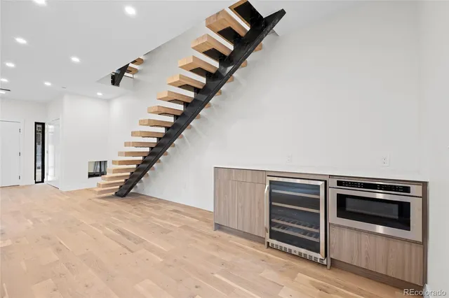 a kitchen with stainless steel appliances granite countertop a sink and a refrigerator