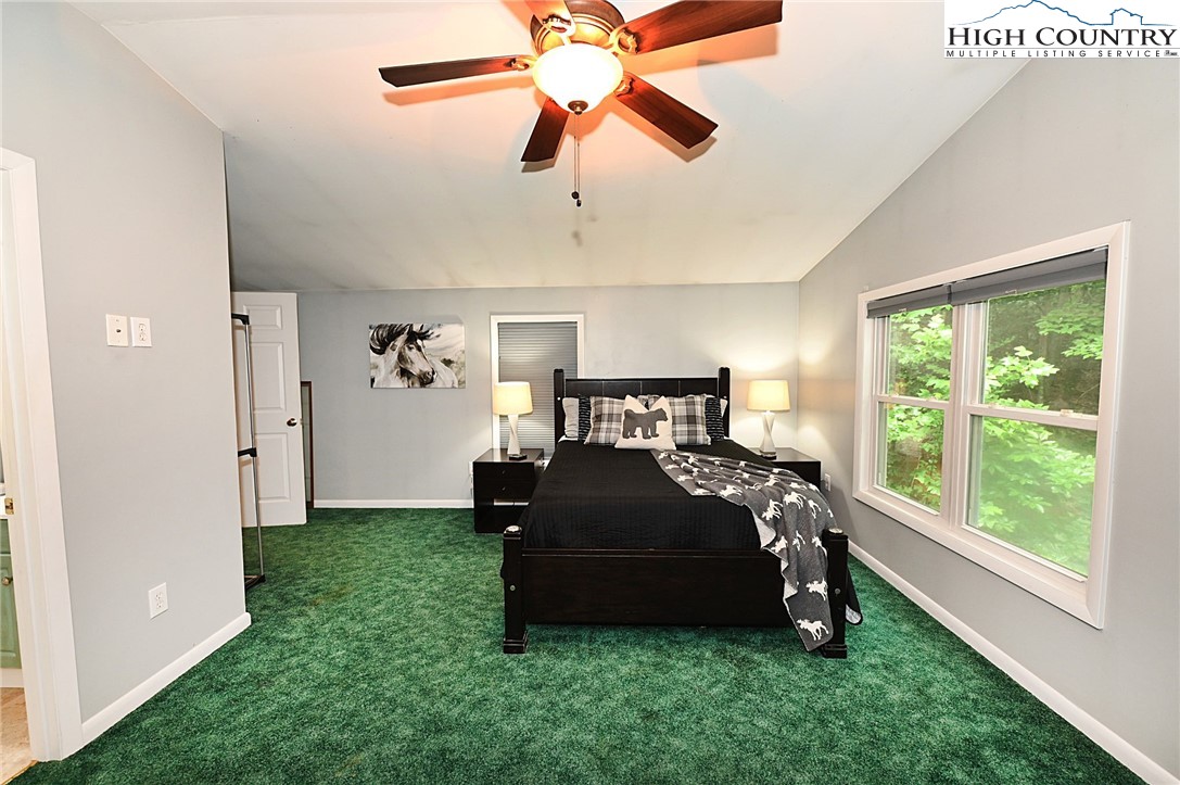 3430-3390 Rose Creek Road Morganton, NC 28655 - Photo 19 of 50 a bedroom with a bed and a chandelier