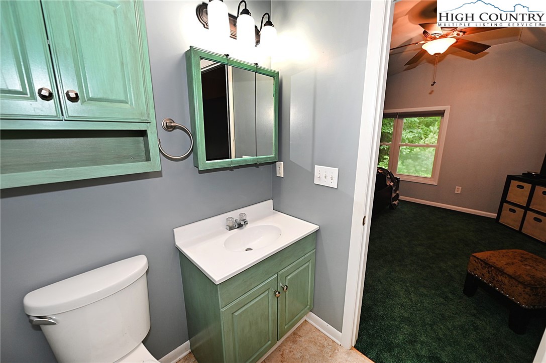 3430-3390 Rose Creek Road Morganton, NC 28655 - Photo 20 of 50 a bathroom with a toilet sink and mirror