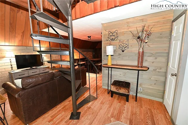 a view of living room with furniture and a fireplace