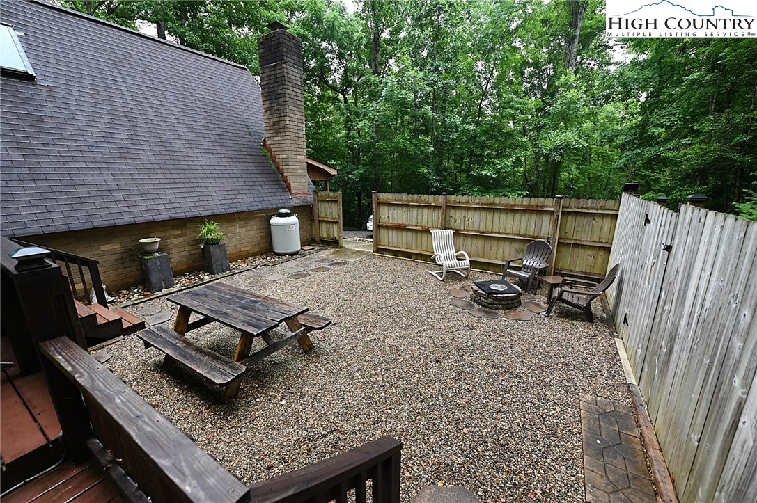 3430-3390 Rose Creek Road Morganton, NC 28655 - Photo 37 of 50 a view of a backyard with chairs and a grill