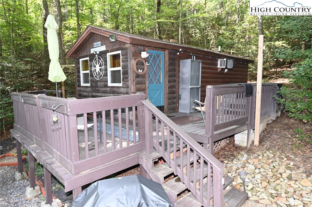 3430-3390 Rose Creek Road Morganton, NC 28655 - Photo 42 of 50 a view of a house with wooden deck and a forest