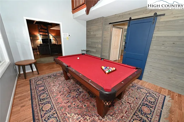a room with pool table and windows