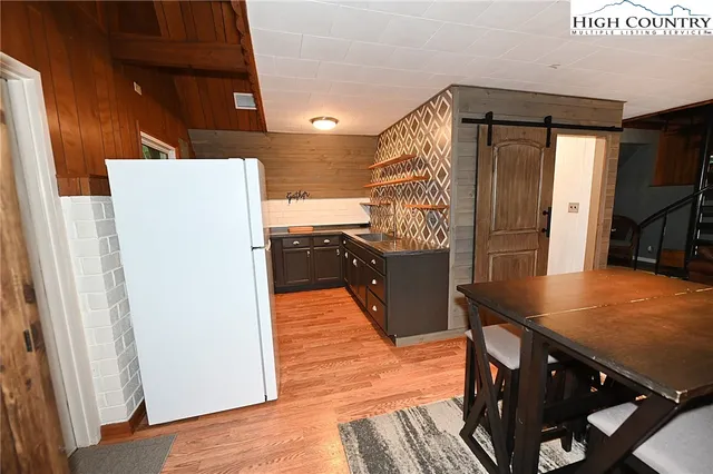 a kitchen with stainless steel appliances a refrigerator and a stove