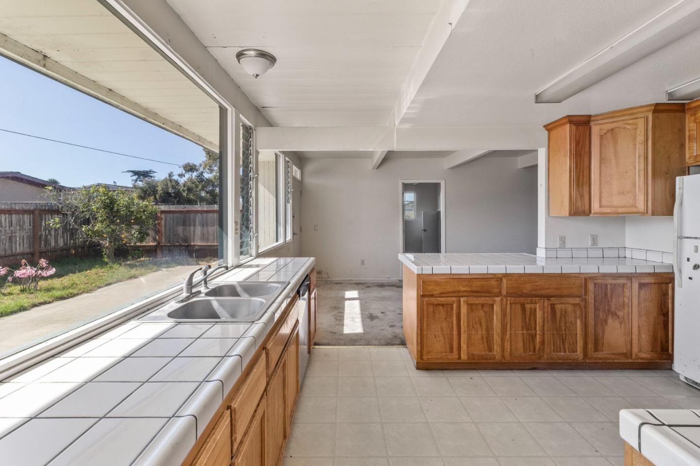 220 Mortimer Lane Marina, CA 93933 - Photo 12 of 42 a large kitchen with stainless steel appliances granite countertop a sink and cabinets
