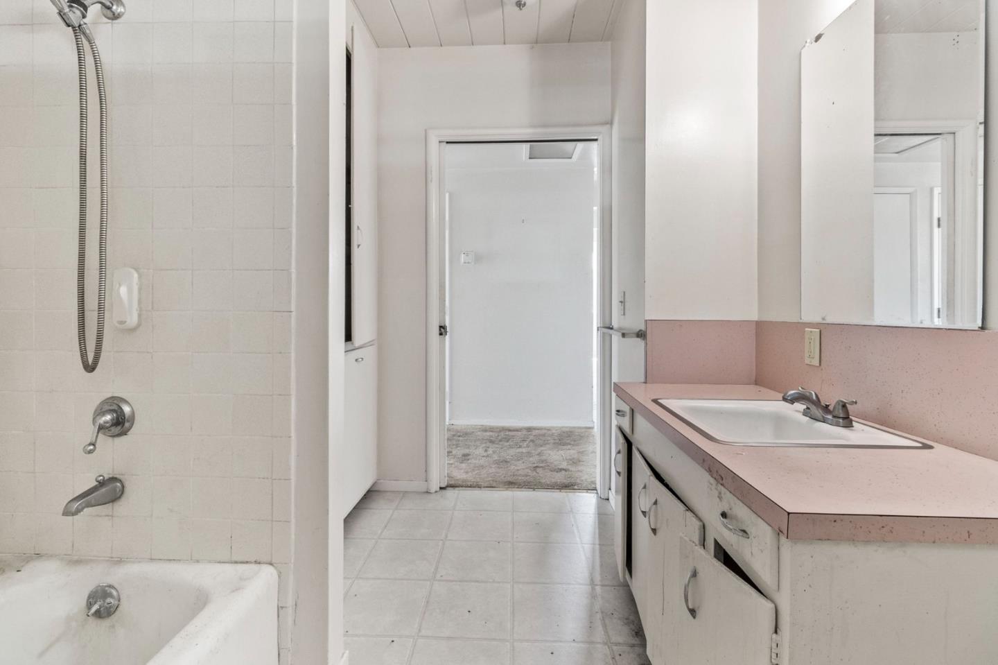 220 Mortimer Lane Marina, CA 93933 - Photo 22 of 42 a bathroom with a granite countertop sink a mirror and a bathtub