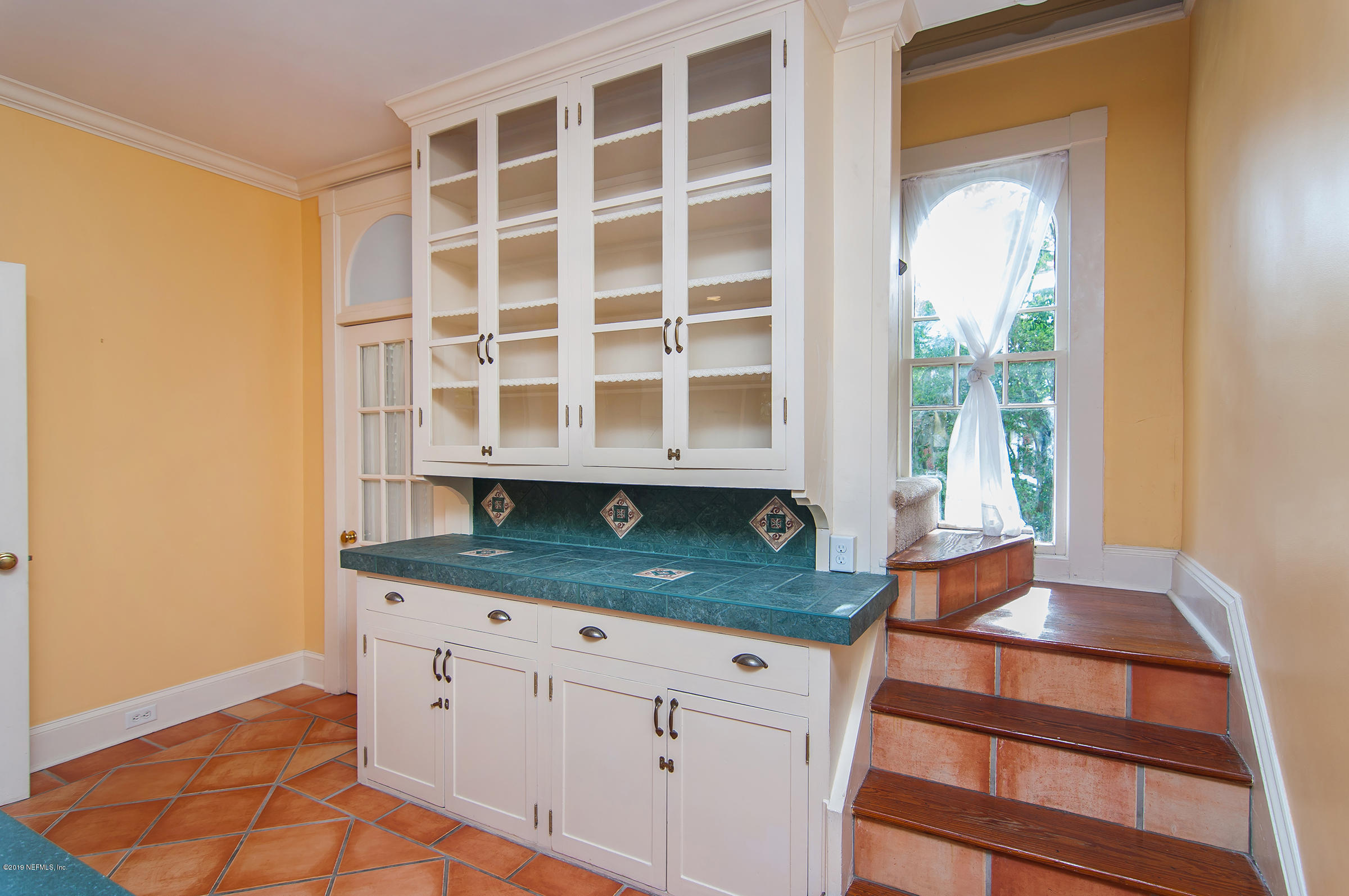 39 Valencia Street St. Augustine, FL 32084 - Photo 27 of 58 a kitchen with granite countertop a sink and a white stove next to a window