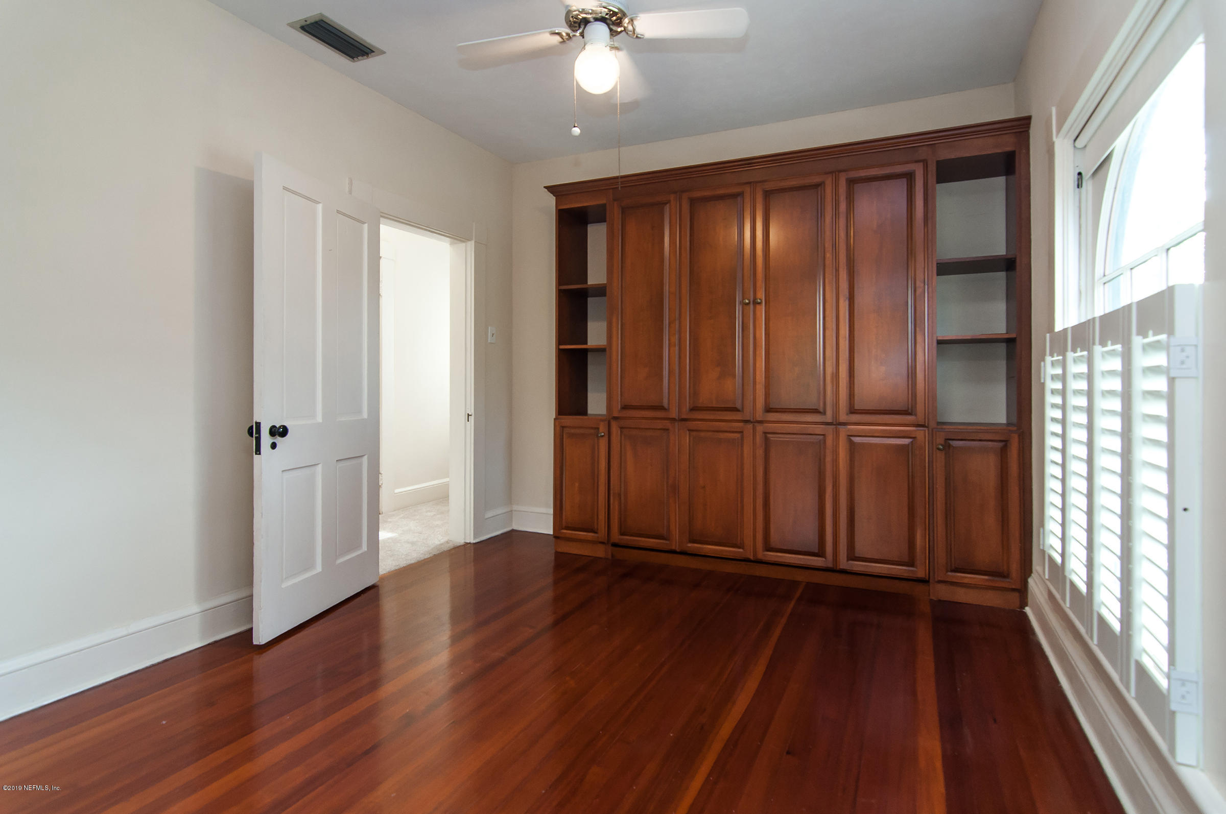 39 Valencia Street St. Augustine, FL 32084 - Photo 29 of 58 wooden floor in an empty room with a window