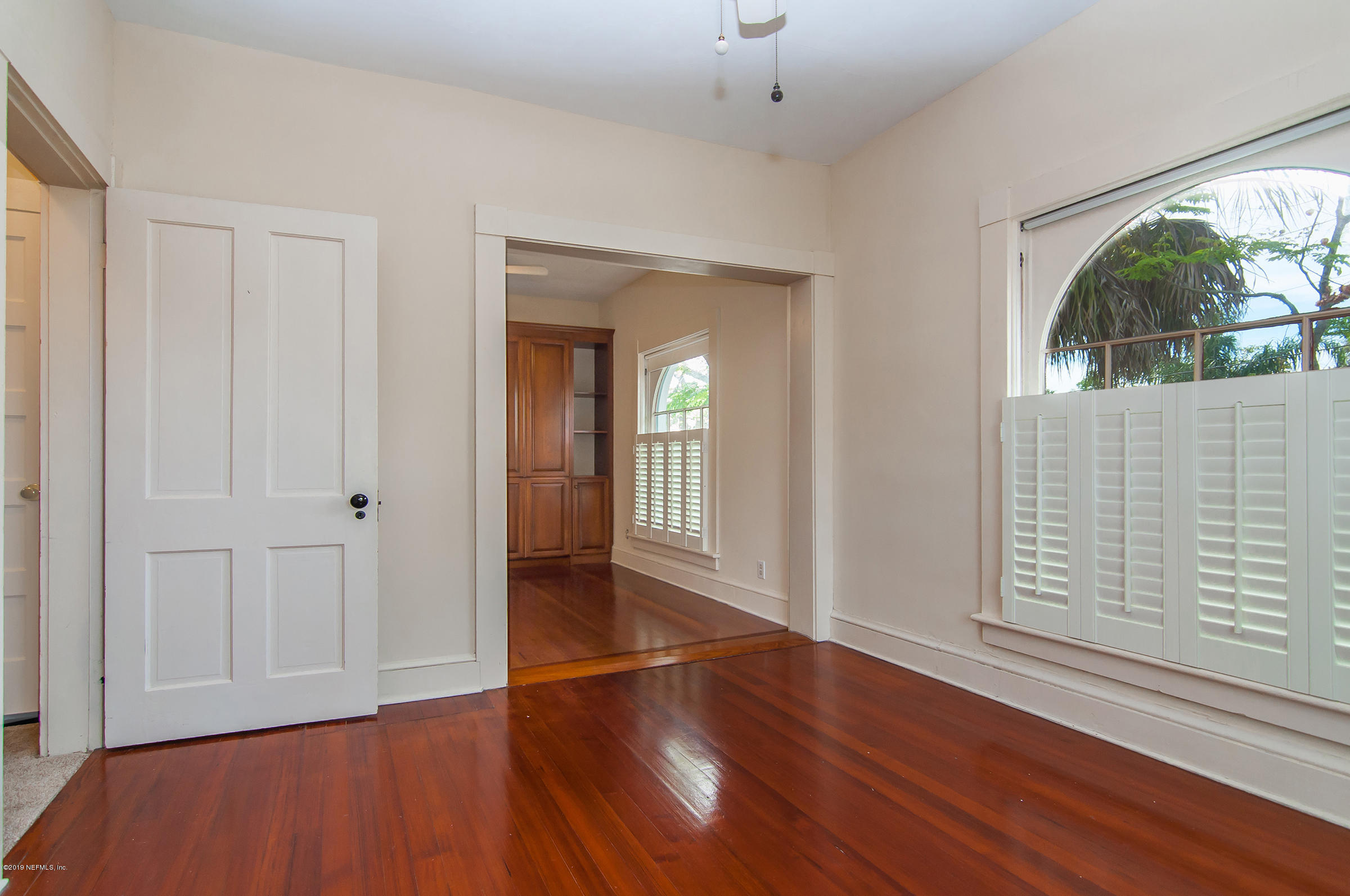 39 Valencia Street St. Augustine, FL 32084 - Photo 32 of 58 wooden floor in an empty room with a window