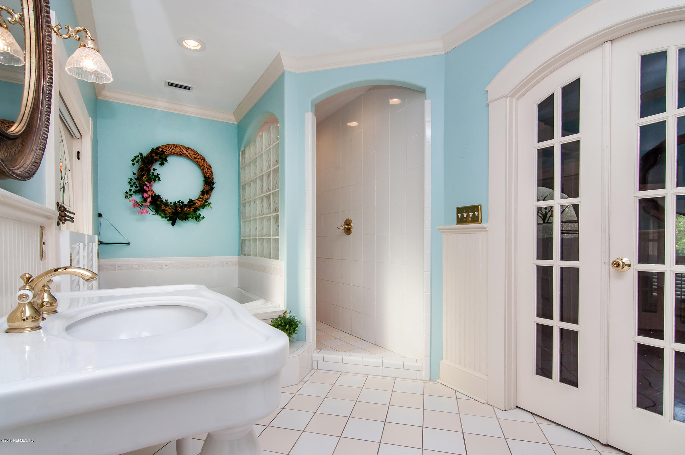 39 Valencia Street St. Augustine, FL 32084 - Photo 40 of 58 a bathroom with a tub sink and mirror
