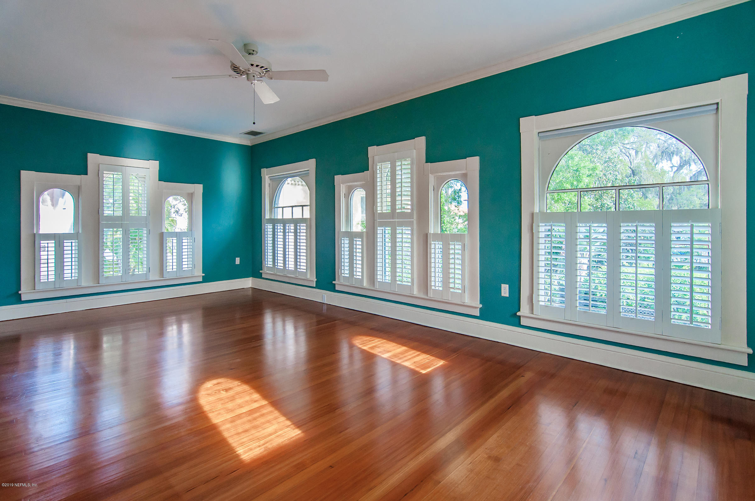 39 Valencia Street St. Augustine, FL 32084 - Photo 43 of 58 a view of an empty room with wooden floor and a window