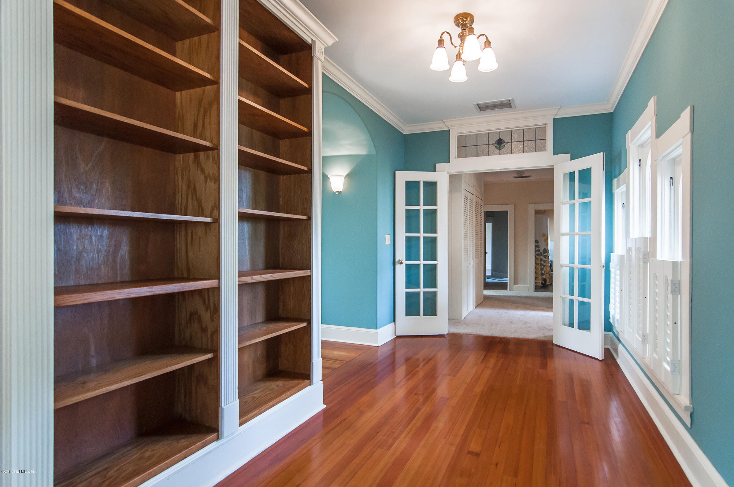 39 Valencia Street St. Augustine, FL 32084 - Photo 45 of 58 a view of an empty room with wooden floor and a window