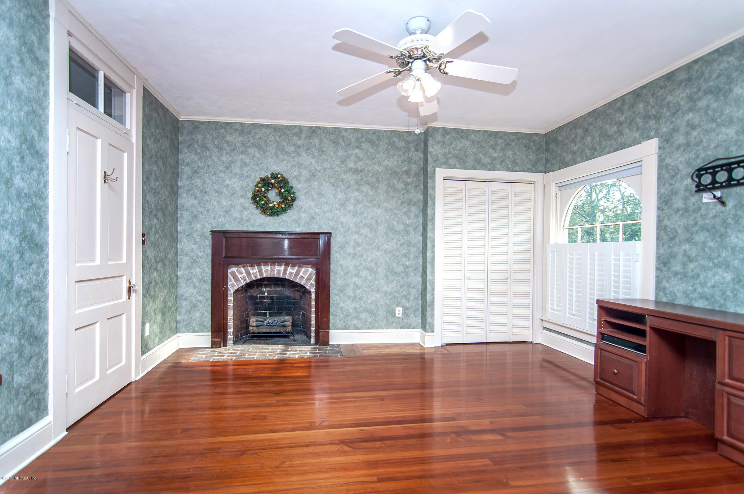 39 Valencia Street St. Augustine, FL 32084 - Photo 46 of 58 a view of a livingroom with a fireplace wooden floor and a chandelier