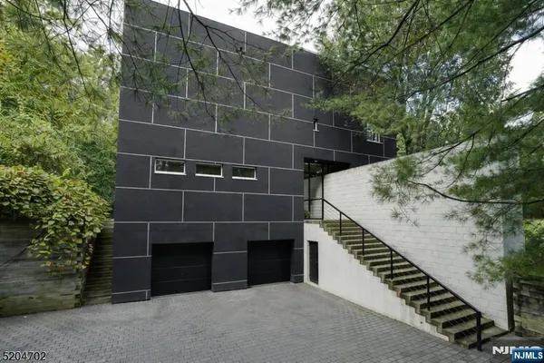 a view of a garage with a tree