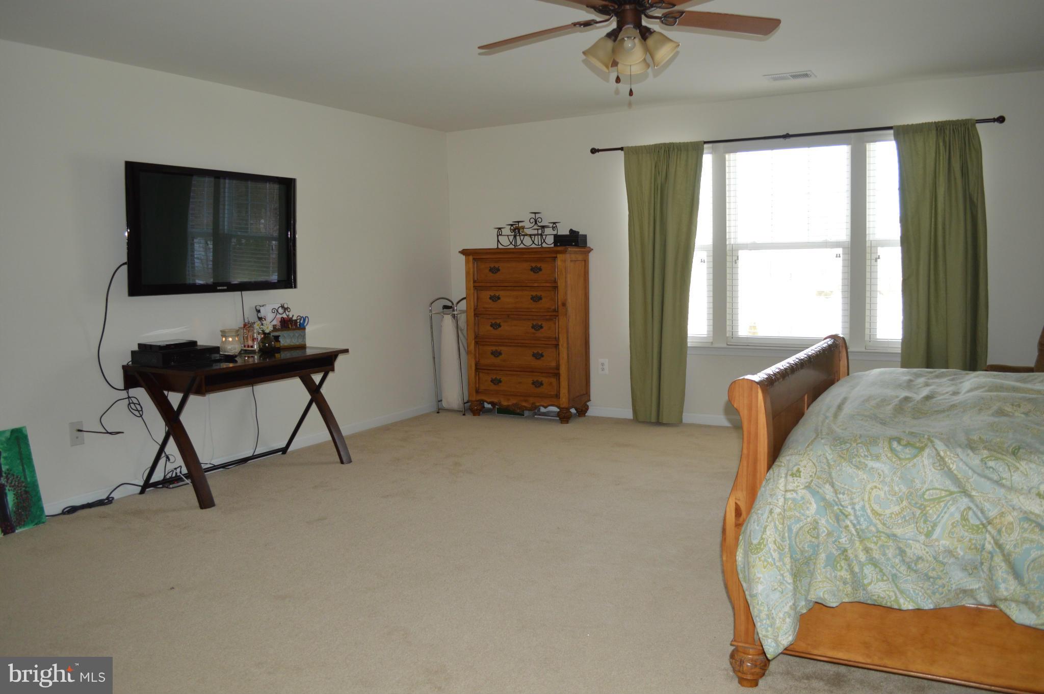 4229 Meyers Road Triangle, VA 22172 - Photo 14 of 29 a bedroom with a bed and a chandelier