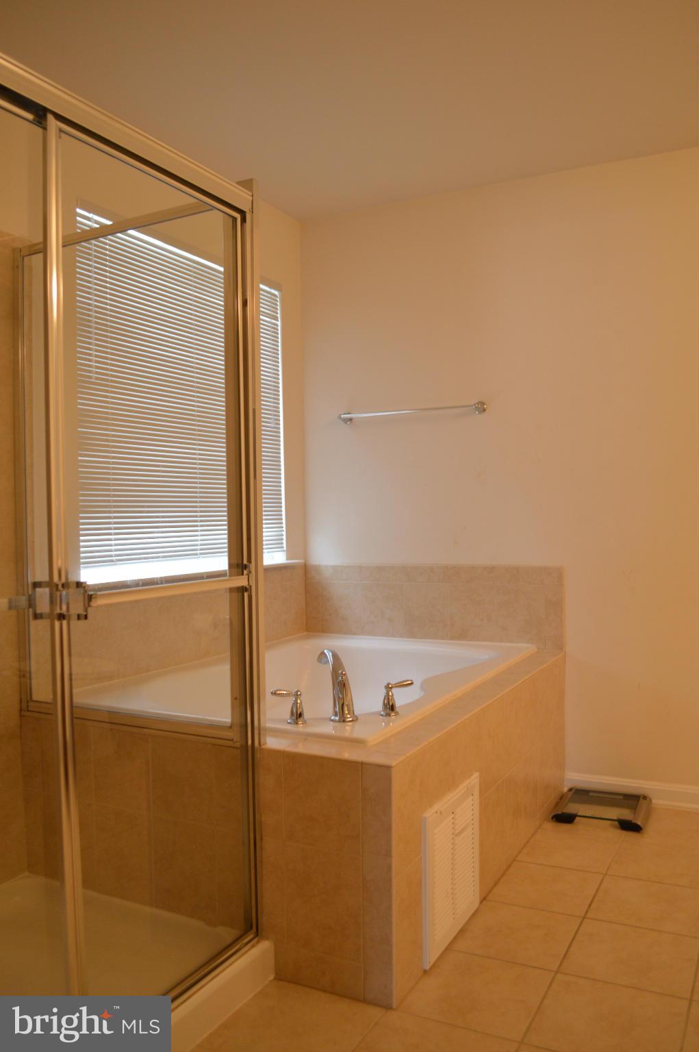 4229 Meyers Road Triangle, VA 22172 - Photo 15 of 29 a bathroom with a bathtub and a shower