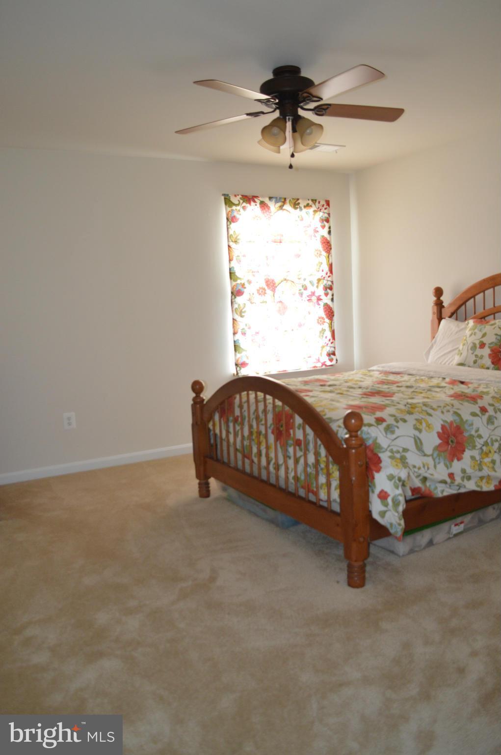 4229 Meyers Road Triangle, VA 22172 - Photo 21 of 29 a bedroom with a bed and a chandelier