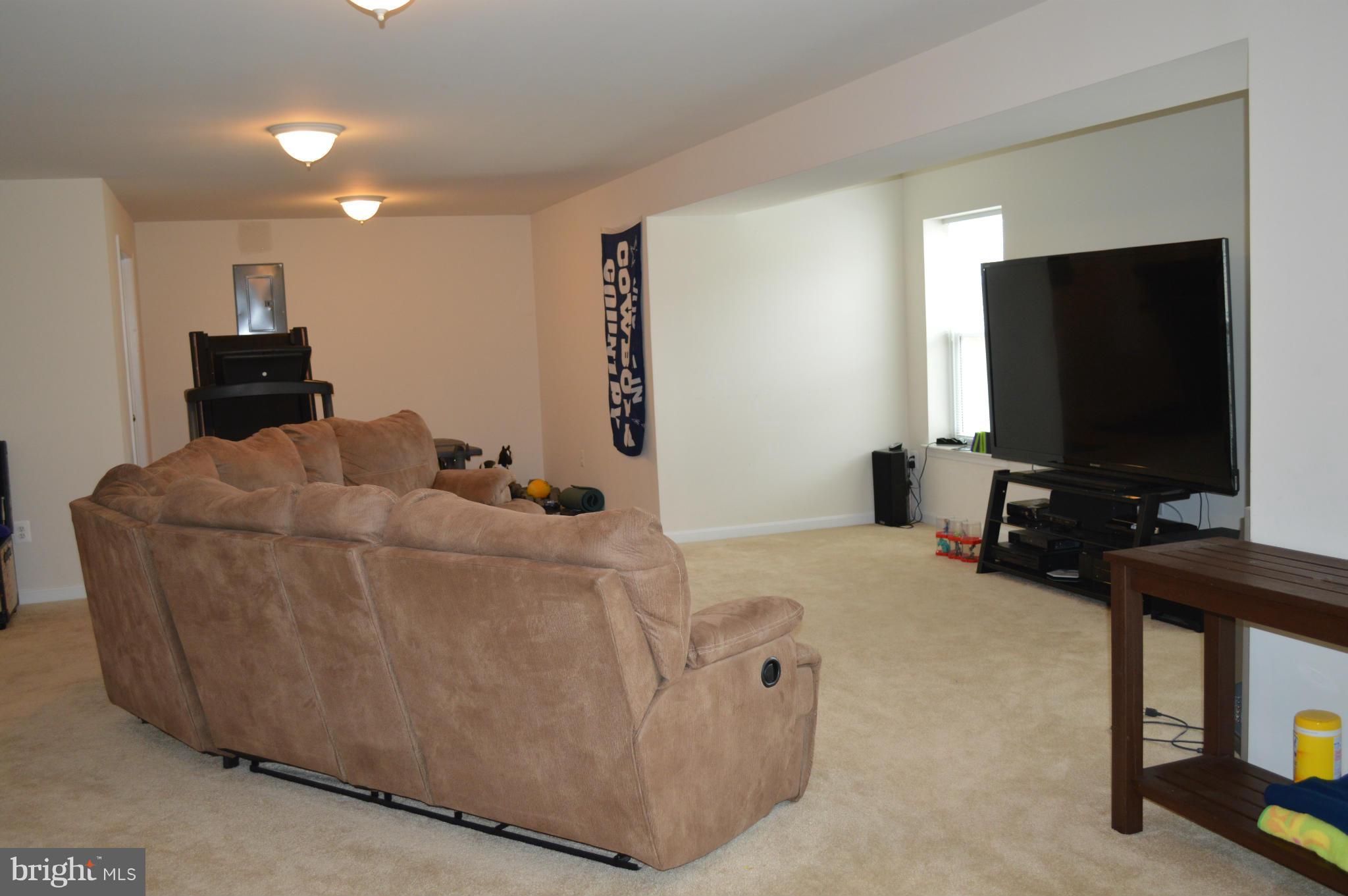 4229 Meyers Road Triangle, VA 22172 - Photo 23 of 29 a living room with furniture and a flat screen tv