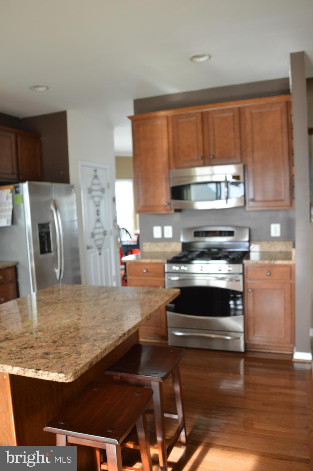 4229 Meyers Road Triangle, VA 22172 - Photo 7 of 29 a kitchen with stainless steel appliances granite countertop a stove and a sink