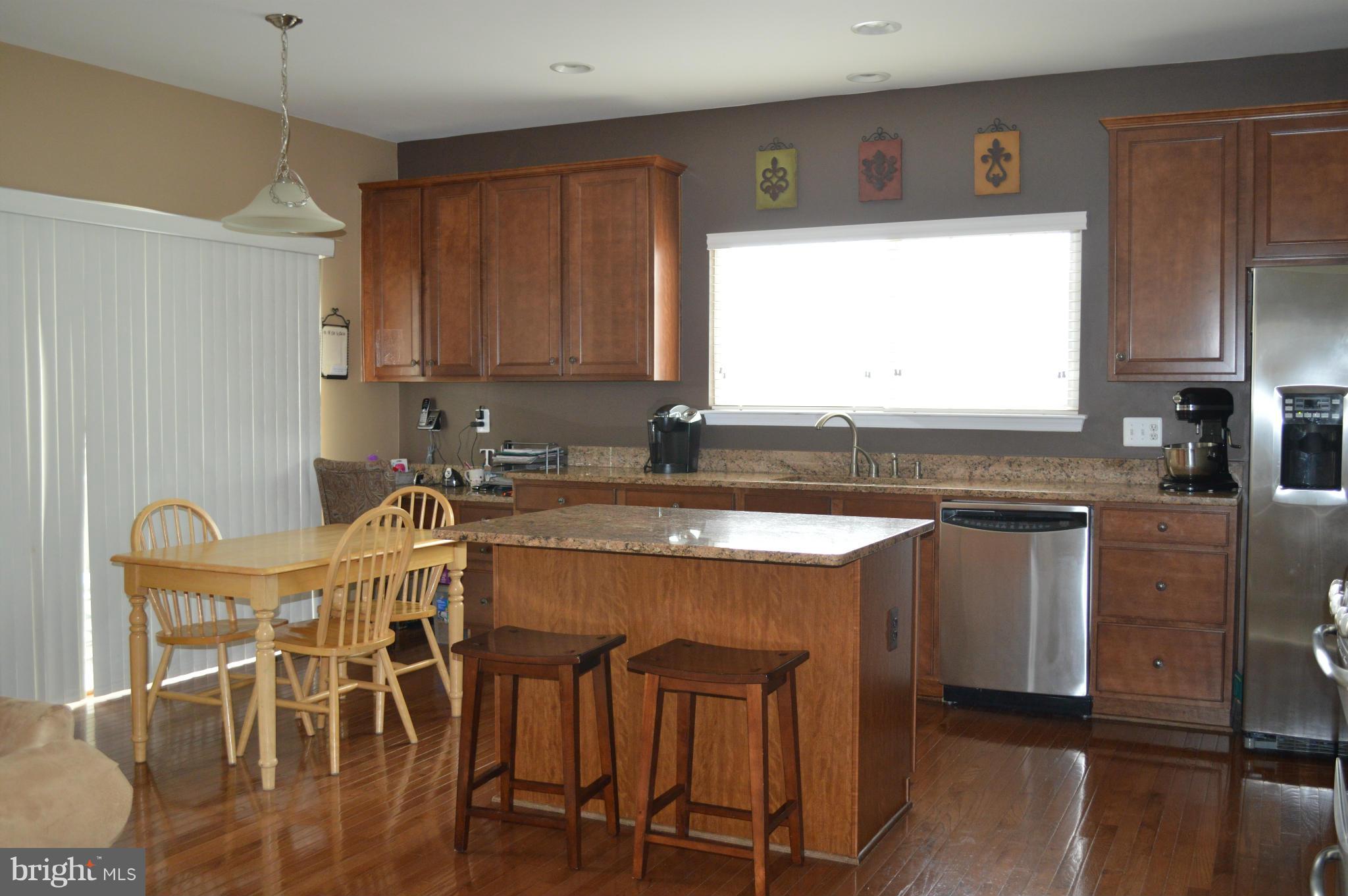 4229 Meyers Road Triangle, VA 22172 - Photo 8 of 29 a kitchen with stainless steel appliances granite countertop white cabinets a sink and a stove