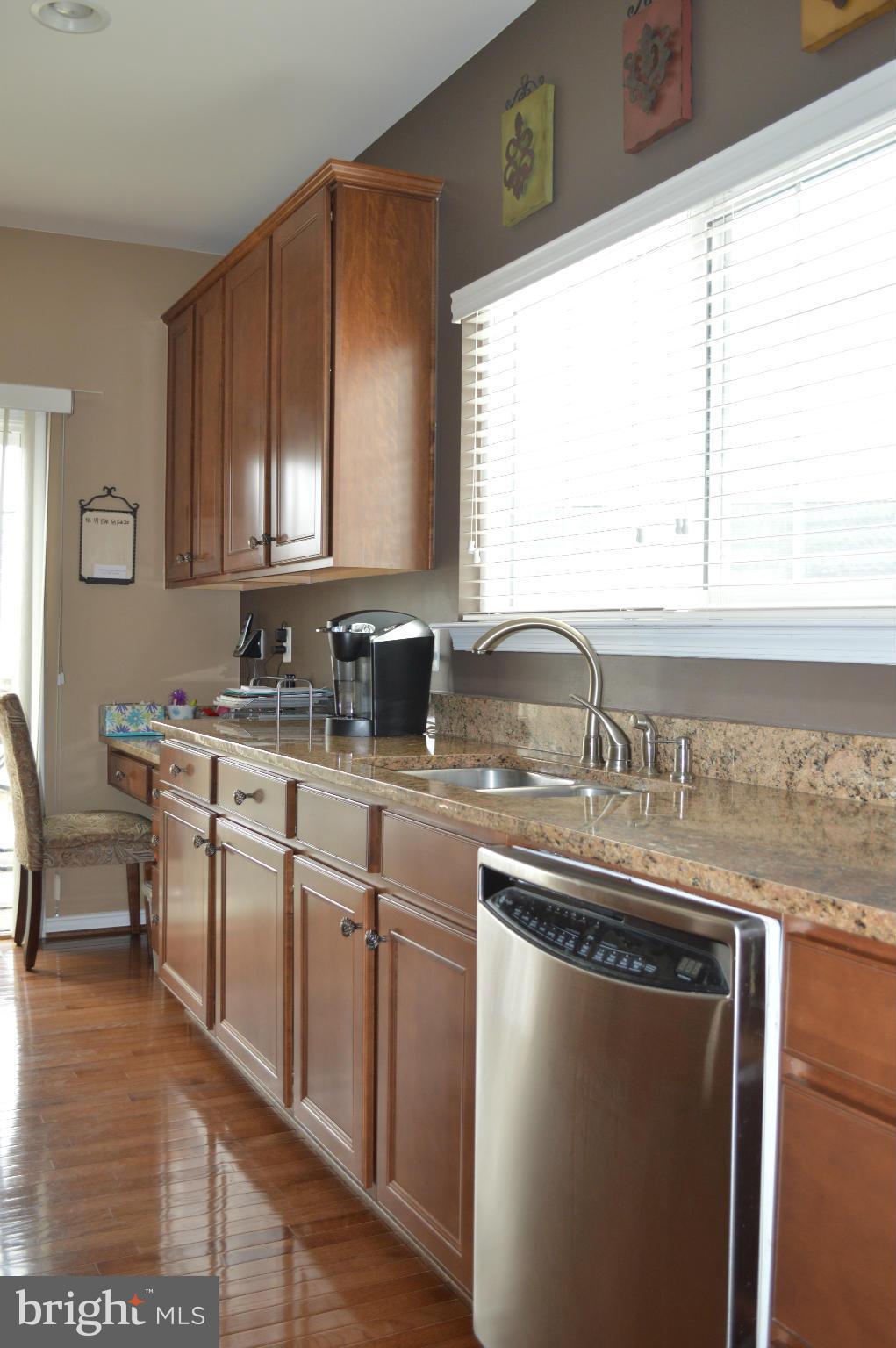 4229 Meyers Road Triangle, VA 22172 - Photo 9 of 29 a kitchen with stainless steel appliances granite countertop a sink a stove and a window