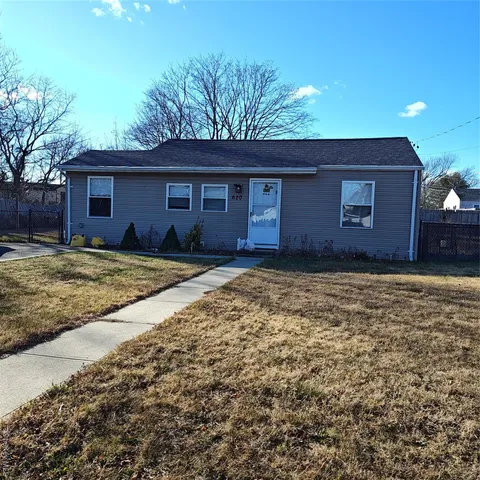 a house that has a tree in front of it