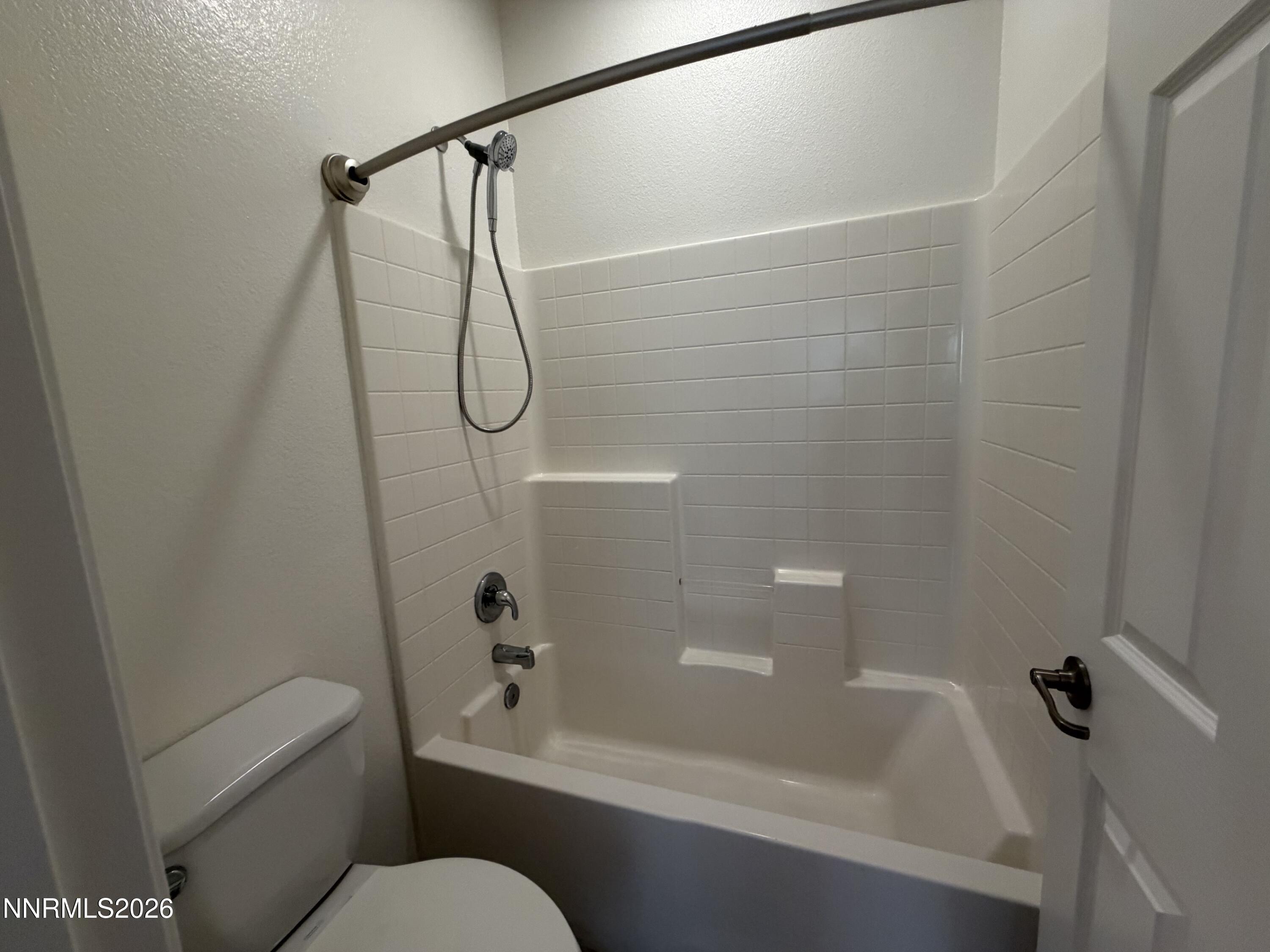 10890 Oakhaven Drive Reno, NV 89521 - Photo 22 of 28 a bathroom with a granite countertop bathtub shower sink vanity and toilet