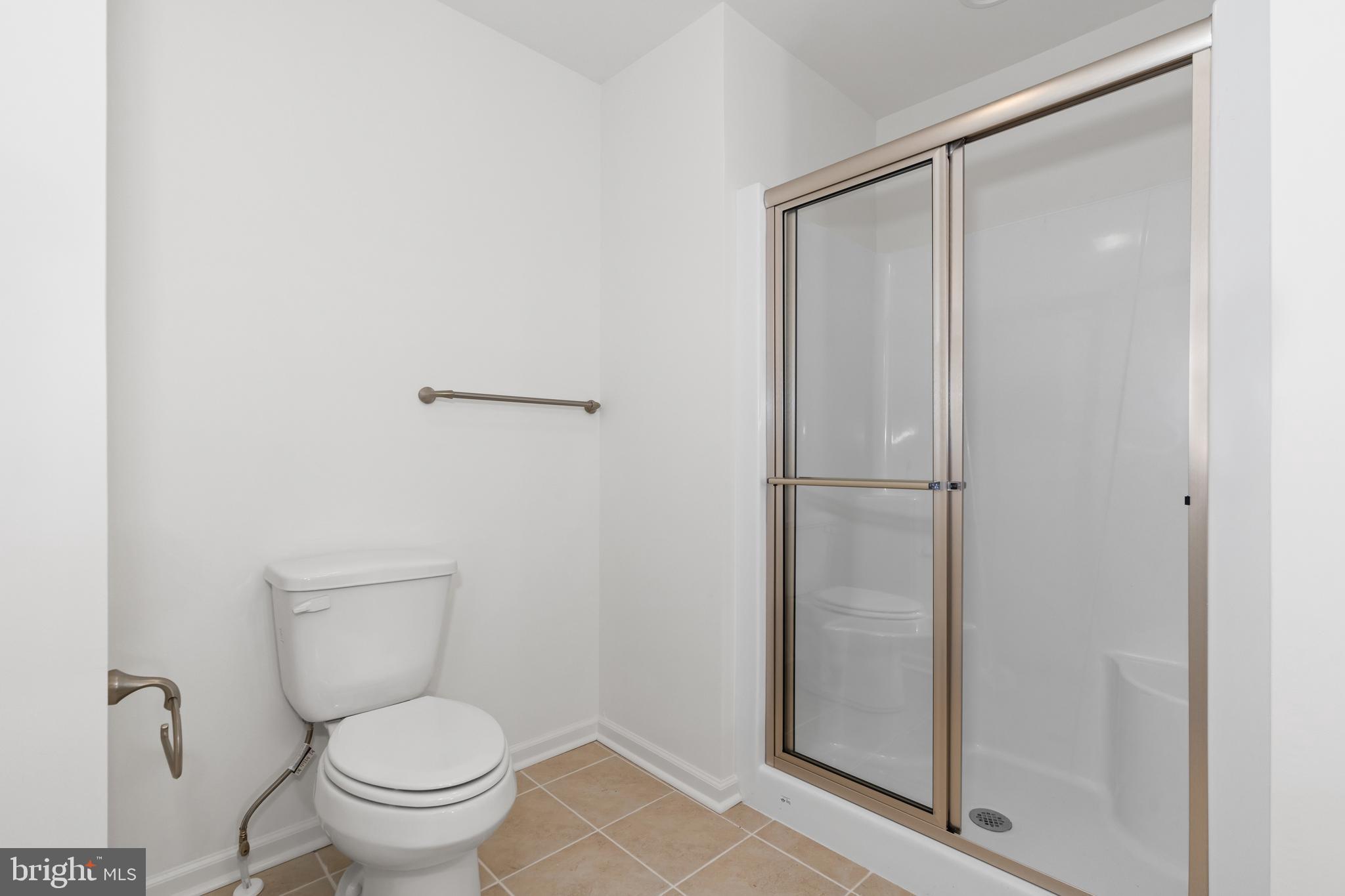 838 Mapleton Avenue, Unit 205 Middletown, DE 19709 - Photo 13 of 19 a bathroom with a granite countertop toilet and a sink