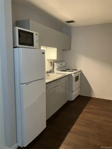 a kitchen with a sink and a refrigerator