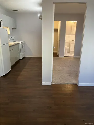 a view of a kitchen with a sink dishwasher and a refrigerator