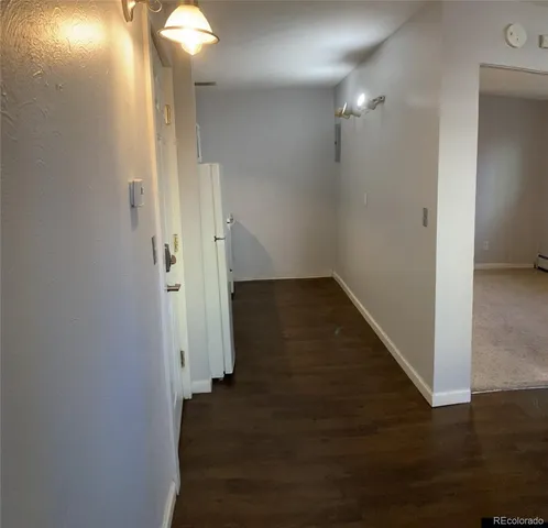 a view of a hallway with wooden floor