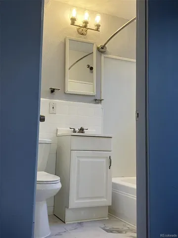 a bathroom with a sink a toilet and mirror