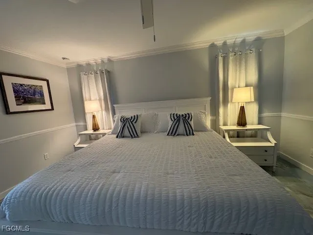a bedroom with a large bed and a window