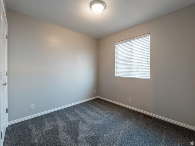 1446 West 1450 North Layton, UT 84041 - Photo 11 of 16 Neutral-toned walls complement the textured gray carpeting