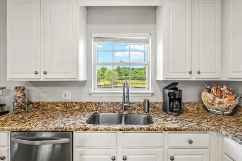 a view of a dining room with furniture and a window