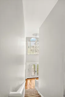 a view of a bedroom with large bed and large windows