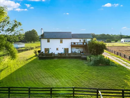a view of a house with a yard porch and sitting area