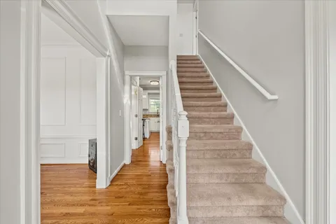 a kitchen with granite countertop a sink cabinets and wooden floor