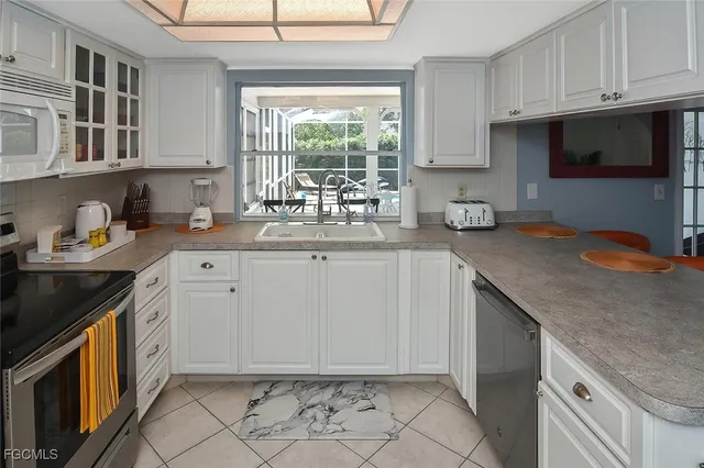 a kitchen with a sink and a stove