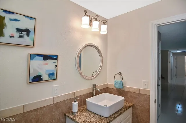 a living room with a dresser and a window